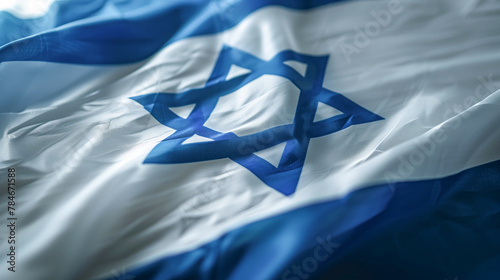 Close up of the Israeli flag with a blue Star of David in the center. Shallow depth of field