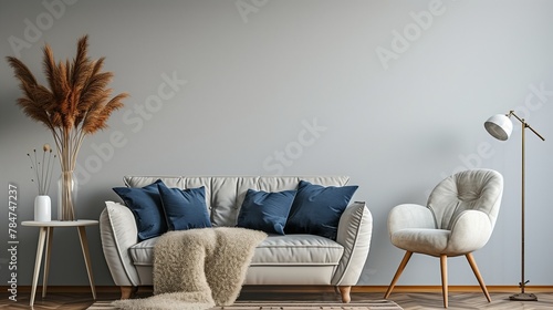 Modern home interior. Couch with blue pillows, vintage armchair on wooden floor, lamp and white table