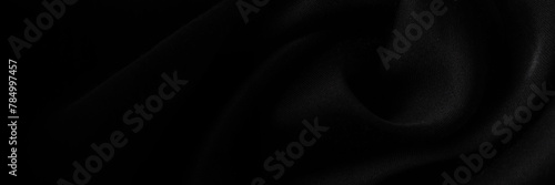 Black silk or satin texture background. Luxury fabric textile for fashion cloth, banner size