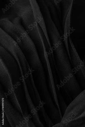 Close up of silk black pleated fabric texture, plisse fabric cloth background
