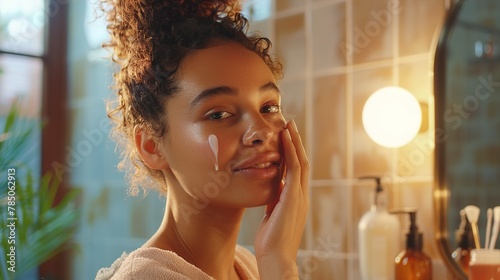 A woman with a satisfied smile as she pats on a hydrating essence, the high-resolution image capturing the subtle glow and the mirror reflecting her contentment.