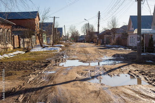 Maloyaroslavets, Russia - April 2018: Uspenskaya Street in the town of Maloyaroslavets, a bad road with mud and puddles in the spring