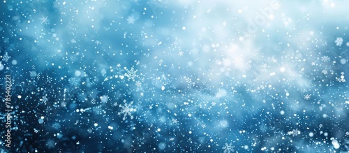 Blue background with snow flakes falling gently, creating a serene winter scene.