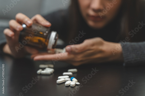 Anti drug, drug addict asian young woman, girl hand reaching for syringe, medicament with narcotic on table at home, abuse overdose. Sick pain of health, unhealthy people. Suicide depressed or despair