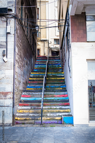 Gijón's narrow lanes boast vibrant stairs, cultural landmarks amidst the urban tourist hub.
