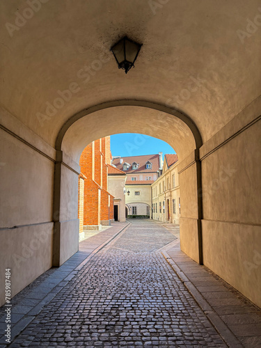 Narrow sunny street between colorful buildings of old town, City street of old town in Warsaw.