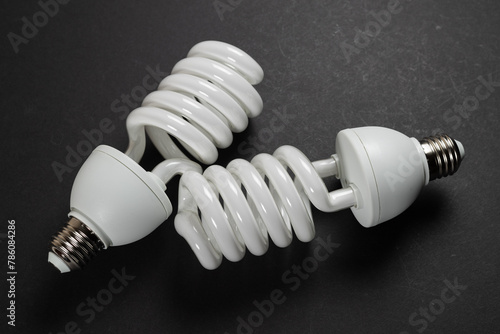 Energy saving fluorescent light bulb on dark background