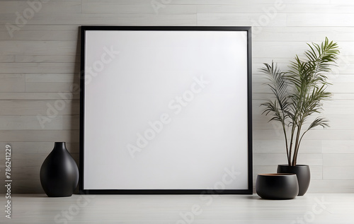 Close-up mock-up of a blank poster with a sleek black frame against a neutral white wall design