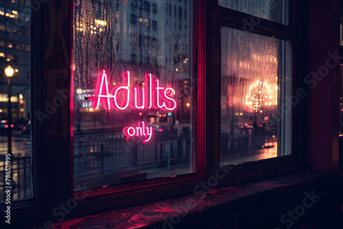 Pink neon light sign with 'Adults only' text hanging in window of bar at night