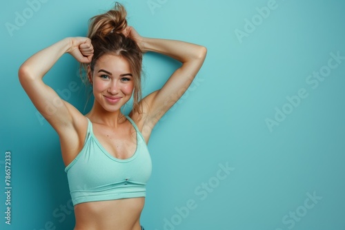 Assertive lady flaunts strength with biceps flexed against clean canvas for text placement