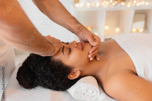 Therapeutic face massage in a serene spa