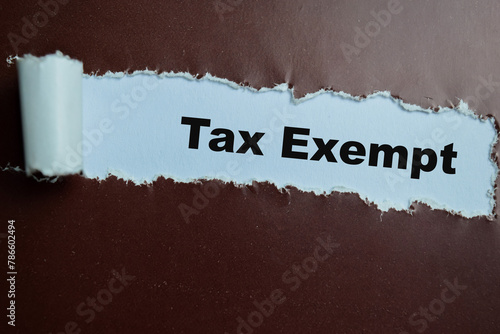 Concept of Tax Exempt Text written in torn paper.