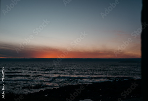 Twilight glow over coastal waters in Larino, Galicia