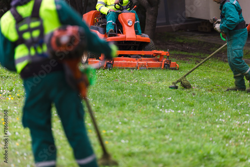 Landscapers working with lawn equipment