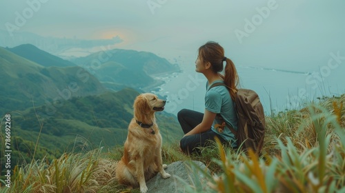 friendship concept picture of a backpacker woman and her golden retriever dog travel together at beautiful mountain range.