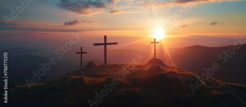 A crosses on the top of the mountain at sunrise, religion concept. 