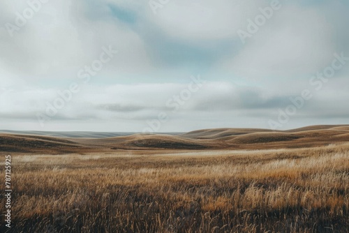 beautiful scene of brown rolling hills with white and brown mountains and a brown grass field covered with clouds in the sky in a cloudy day in the morning
