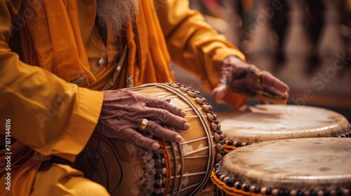 Sikh drummer in a yellow robe playing Indian tabla drums associated with the Baisakhi festival, banner