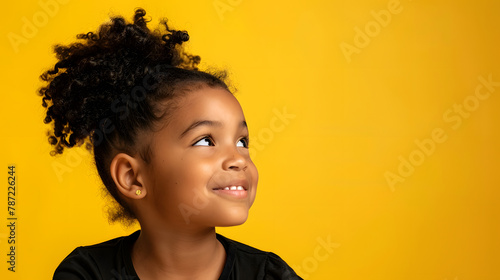 Pensive smiling African American girl isolated on yellow studio background look at copy space aside Happy biracial teen child consider good sale deal or promotion offer Advertising con : Generative AI
