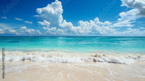 a beach with waves and blue sky