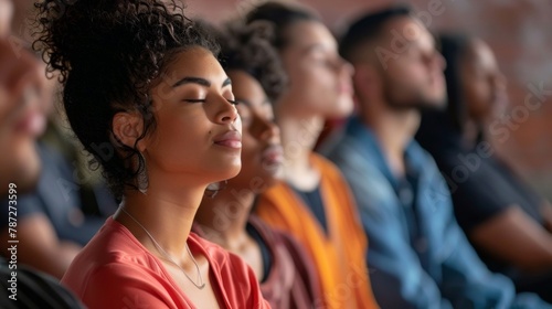 A group of people sitting in a circle with their eyes closed participating in a guided meditation using bioacoustic sound therapy. .