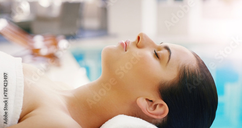 Spa, salon and woman relax at pool for massage, facial treatment and luxury pamper. Aesthetic, dermatology and person with eyes closed at resort for wellness, cosmetics service and beauty therapy