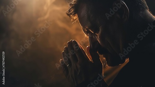 man praying with hands clasped in darkness spiritual devotion and faith