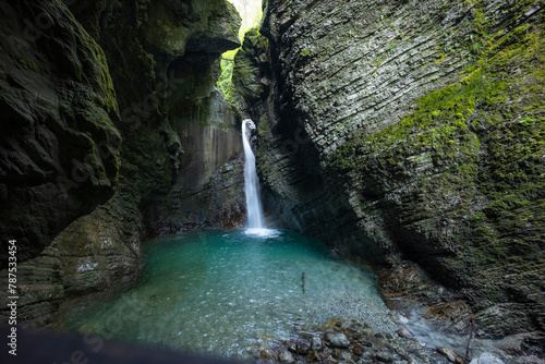 Caporetto, Slovenia. Kozjak waterfalls. Nature trail along the river with crystal clear, turquoise water, Tibetan bridges and a waterfall inside the cave with a nature pool. easy trekking, wood path.