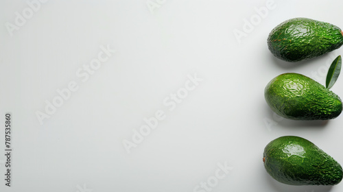 Three avocados arranged vertically on a white background. Top view.