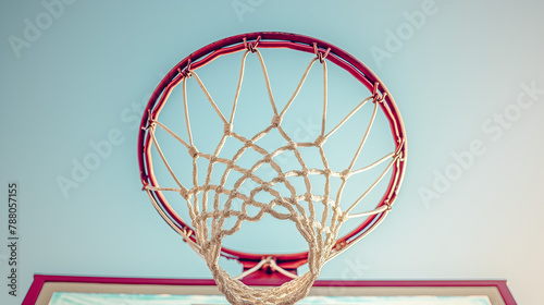 A basketball net is shown in the air with a blue sky in the background
