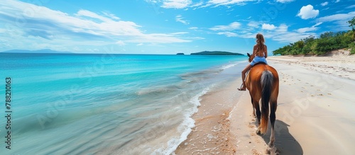 Woman horseback riding on stunning tropical beach paradise under clear blue skies