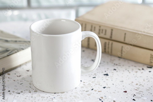 Natural blank white mug POD product mockup minimal empty space on terrazzo table two books background for book lover reader bookworm earthy rural farmhouse boho marketing literary library campaign