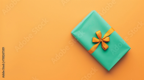 A green gift box with a yellow bow on an orange background.