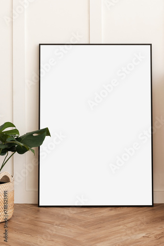 Blank picture frame on parquet floor design element