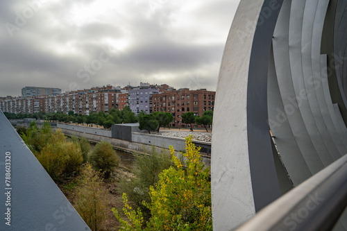 MADRID, SPAIN - November 17, 2023: Arganzuela Bridge in Madrid Rio Park, Designed by Dominique Perrault, it is 274 meters in length and formed by two spiral-shaped walkways . High quality photo