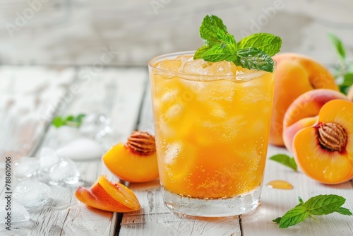 Refreshing Peach Cocktail with Mint Garnish on White Wooden Surface. Ideal Summer Drink with a Sweet and Fizzy Twist