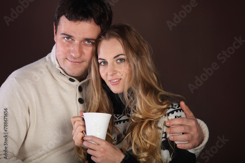Portrait of a happy young couple with cup