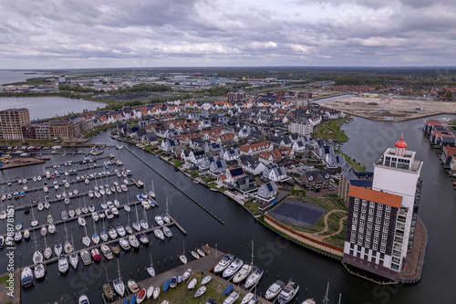 Recreational port and Lighthouse with Dolfinarium park in the background at the Veluwemeer. Aerial residential Dutch area.