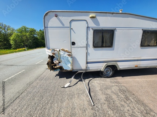 Vintage White Small Travel Trailer with Significant Damage on Rear, Perfect for Fixer-Upper Enthusiasts and DIY Renovation Projects. Great Opportunity for Restoration and Customization.