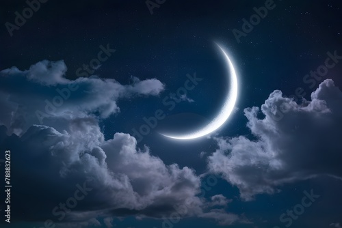 Night sky with stars and clouds illuminated by a crescent moon