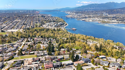 Beautiful aerial view of the skyline of Vancouver and North Burnaby next to the Burrard Inlet during a spring season in British Columbia, Canada