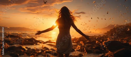 joyful woman raising her hands to the sky, enjoying the summer sunset by the beach