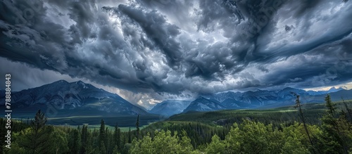 Dramatic clouds above mountains and trees