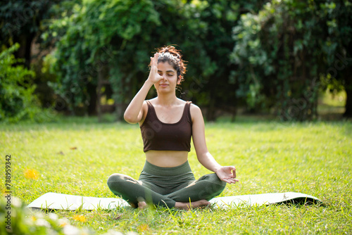 Ravishing Woman Doing Anulom Vilom Pranayama In Park 