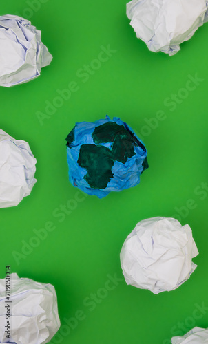 Planet earth made of paper on Green Background