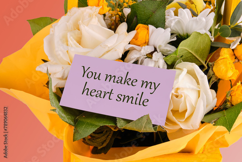 You Make My Heart Smile text on a purple business card in a bouquet of flowers