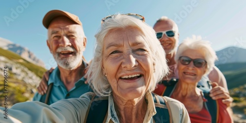 POV of a group of active seniors posing together for a selfie or video call on a sunny day against a mountain view background. Happy retirees exercising together outdoors. Healthy and active living