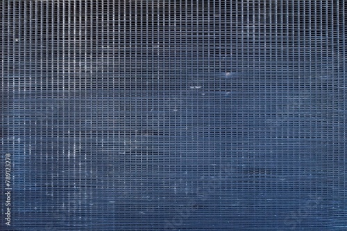 Closeup of a abandoned bus radiator grille abstract background pattern.