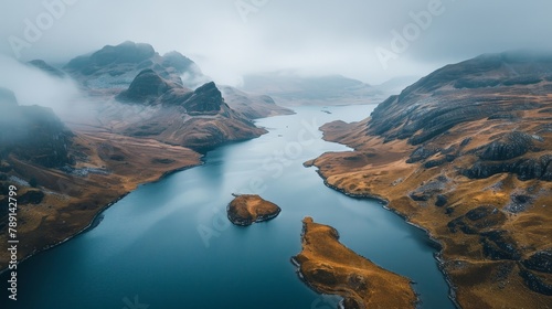 Aerial view of the Scottish Highlands, rugged terrain and misty lochs