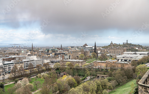 View of Edinburgh Skyline including Carlton Hill, the St James Quarter building, with rain clouds over the Firth of Forth in the distance